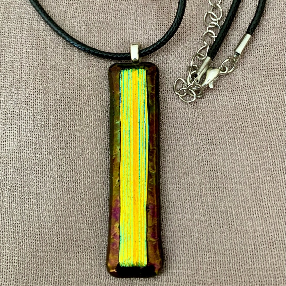 Stunning dichroic pendant on a black cord